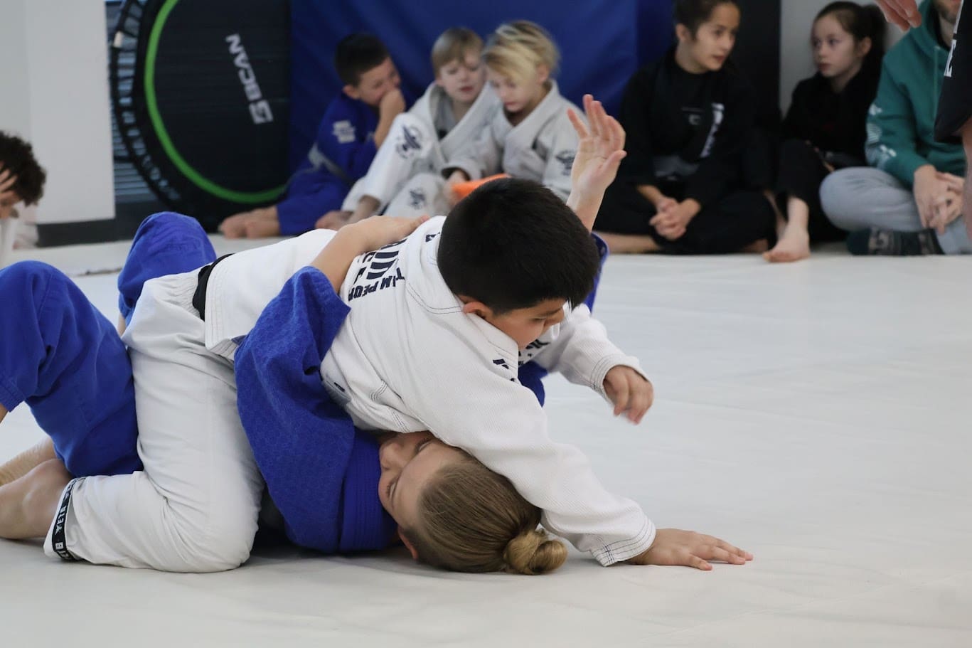 Teens participating in martial arts such as Brazilian Jiu-Jitsu benefit from good physical training and self-defense skills, while also enhancing self-control, self-confidence, life skills, physical capabilities, situational awareness, motor skills, and self-discipline, which help them navigate team sports and peer pressure.